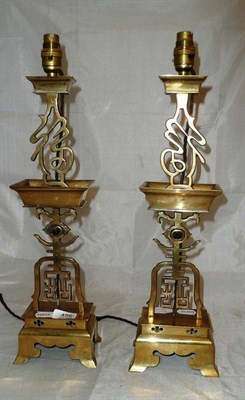 Lot 456 - A pair of Oriental brass candlesticks