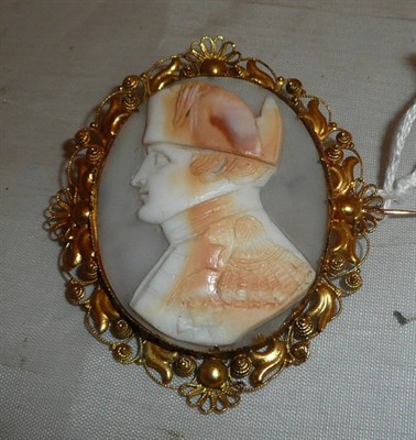 Lot 458 - A Cameo brooch, the shell carved to depict Napoleon Bonaparte, within a scroll and filigree...