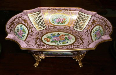 Lot 528 - A large Limoges porcelain bowl with gilt highlights and floral painted vignettes with gilt stand