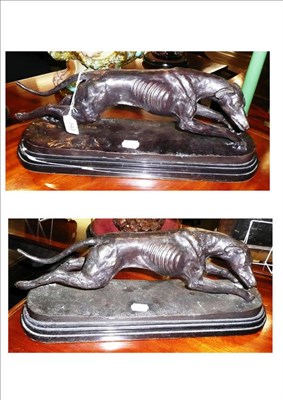 Lot 543 - A pair of reproduction bronze models of running greyhounds, mounted on marble bases