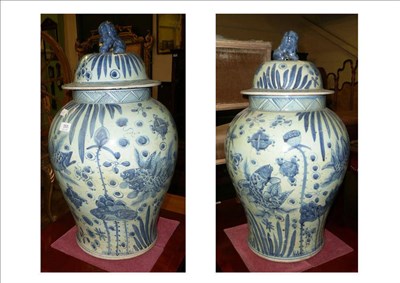 Lot 555 - Pair of blue and white vases and covers