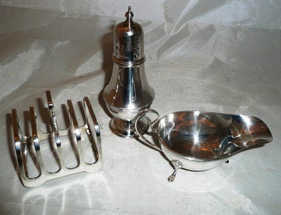 Lot 566 - Silver sauce boat, silver caster and silver toast rack