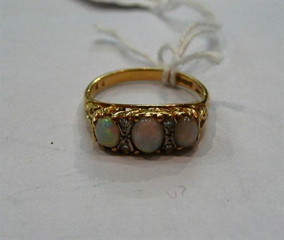 Lot 581 - An 18ct gold opal and diamond ring