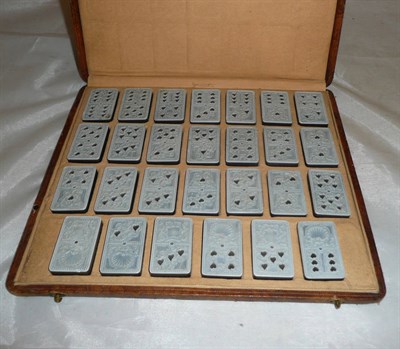 Lot 621 - A set of twenty-seven hardstone dominoes, late 18th/early 19th century, the pale upper surface...