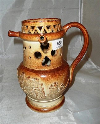 Lot 630 - A 19th century Brampton puzzle jug decorated with scenes of revelry