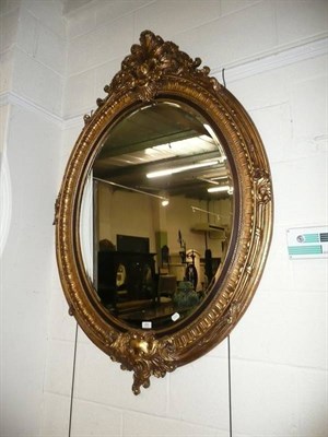 Lot 650 - Large oval gilt mirror