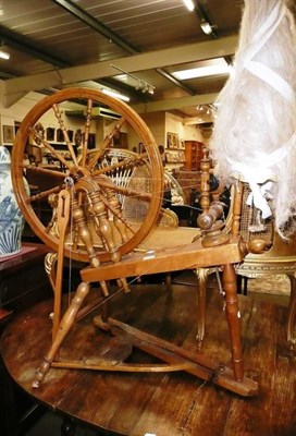 Lot 688 - A beech and fruitwood spinning wheel dated 1884