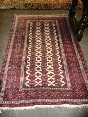 Lot 715 - An Afghan Tekke rug Afghan Turkestan  The ivory field with rows of guls enclosed by narrow borders