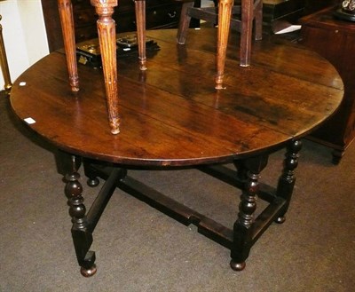 Lot 733 - An early 18th century oak eight-seater gateleg dining table, on eight turned and block legs,...