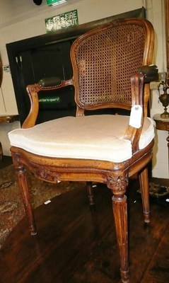 Lot 745 - A stained beech arm chair with cane seat and back