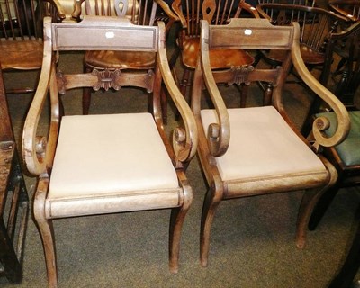 Lot 762 - Two mahogany elbow chairs on sabre legs