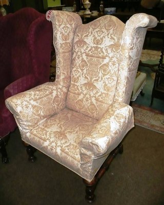 Lot 783 - A 17th century-style walnut wing back chair, probably 19th century, upholstered in cream gold fleur