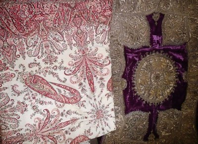 Lot 784 - Possibly Indian 'saddle cloth' embroidered with metallic threads on a purple velvet ground and...