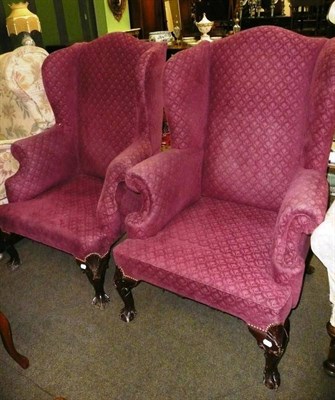 Lot 785 - Pair of early 20th century wingback chairs with claw and ball feet