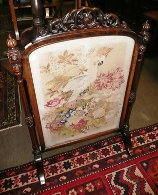 Lot 801 - Victorian carved walnut framed firescreen with a needlework insert depicting a parrot amongst...