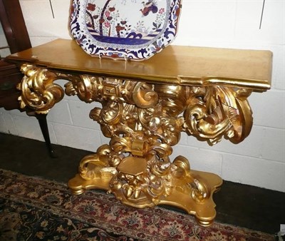 Lot 829 - An 18th century style giltwood and gesso console table, the rectangular top of breakfront form...