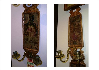 Lot 838 - Pair of gilt two branch wall sconces inset needle work panels