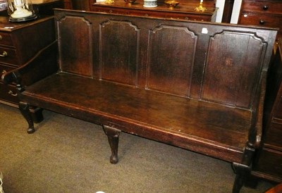 Lot 840 - An 18th century oak settle with fielded back support and later seat