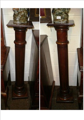 Lot 848 - Three stained mahogany pedestals with fluted columns