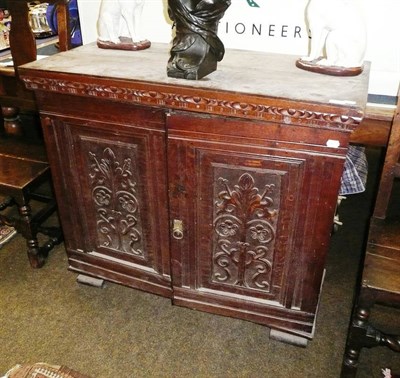 Lot 858 - A carved oak double door cabinet enclosing and arrangement sixteen small drawers