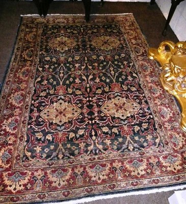 Lot 871 - Afghan rug Afghan Turkestan The mid indigo field of scrolling floral vines and medallions...