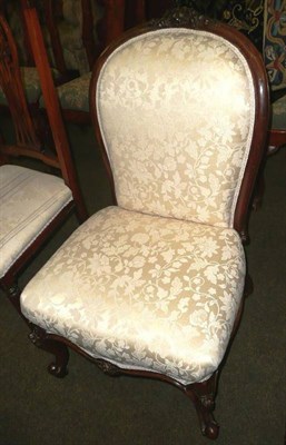 Lot 874 - Lady's Victorian walnut framed low salon chair, upholstered in pale lemon satin damask, on cabriole