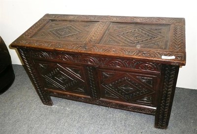 Lot 1047 - Late 17th century oak coffer, twin panelled top and front carved with lozenges and arched...