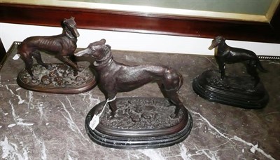 Lot 1059 - Three bronze models of greyhounds, two mounted on marble bases