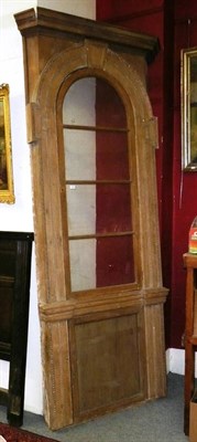 Lot 1066 - A George II stripped pine corner cabinet frame including glazed door