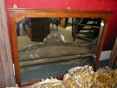 Lot 1073 - A large oak framed over mantel mirror