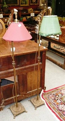 Lot 1110 - A pair of brass floor standing lamps