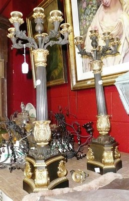 Lot 1192 - Pair of gilt and black candelabra