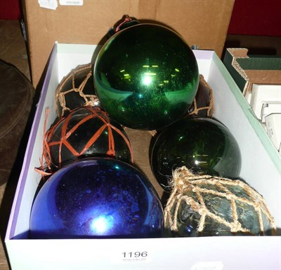 Lot 1196 - Five glass fishing floats and two witches balls