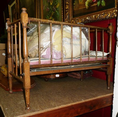 Lot 1202 - A doll's cot, mattress and bedding