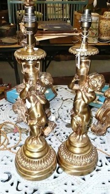 Lot 1230 - A pair of gilt metal cherub table lamps