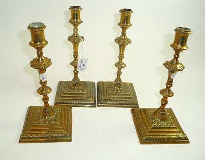 Lot 4 - Set of four brass candlesticks