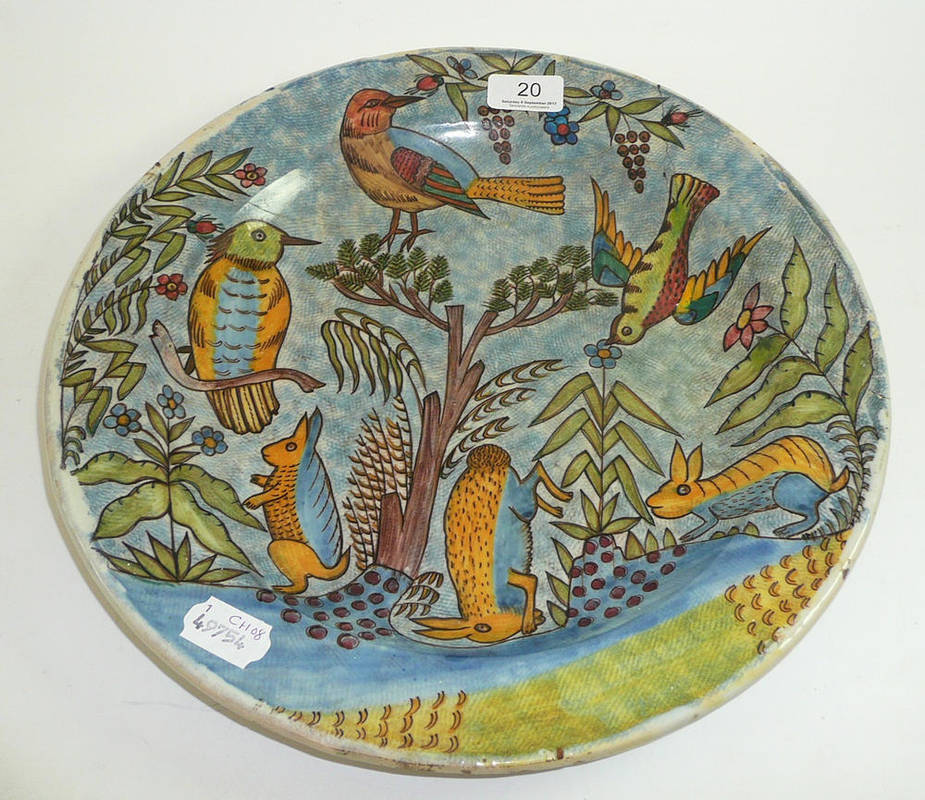 Lot 20 - A Continental tin glazed charger decorated with birds and rabbits (a.f.)