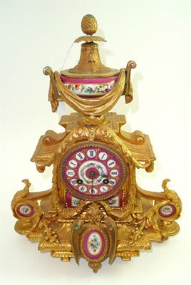 Lot 61 - A French gilt metal mantel clock with porcelain mounts