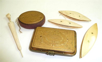 Lot 114 - A tooled brass purse and similar pin cushion, ivory and bone shuttles, umbrella needle case