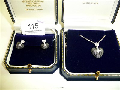 Lot 115 - An 18ct white gold heart shaped pendant on chain set with black and white diamonds, with a pair...