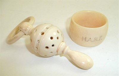Lot 121 - Ivory rattle/teething ring and napkin ring