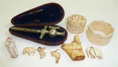 Lot 122 - An ivory box and cover, napkin ring, champagne tap, stag horn netsuke etc
