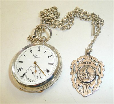 Lot 131 - A silver open faced pocket watch signed J W Benson, with a silver watch chain and attached...