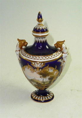 Lot 216 - A Royal Worcester blue and gilt decorated vase, with central panel decorated with landscape, signed