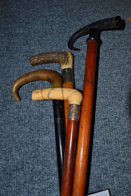 Lot 257 - An ivory handled walking stick, a Gam handled walking stick and two others