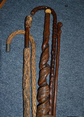 Lot 258 - Basket weave walking stick and four assorted holly/treen walking sticks