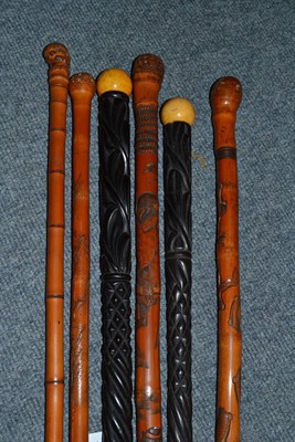 Lot 261 - Six Oriental/Eastern carved walking sticks