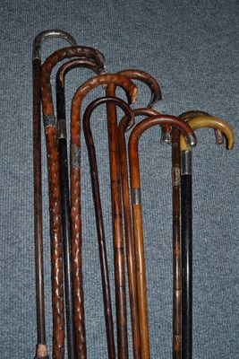 Lot 263 - Ten assorted cane and ebonised walking sticks with silver pommels and collars