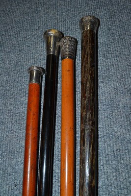 Lot 265 - Four walking canes with silver pommels including a Malacca example