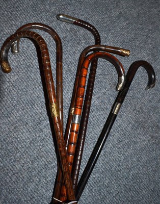 Lot 270 - Six assorted cane walking sticks with assorted silver and gilt pommels and collars